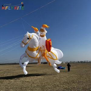 A white and gold inflatable knight on horseback kite with a red shield.