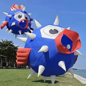 Blue and orange inflatable fish kites with large eyes and pointed fins.