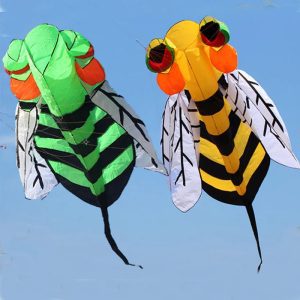 Green and yellow insect-shaped kites with large eyes and striped bodies.